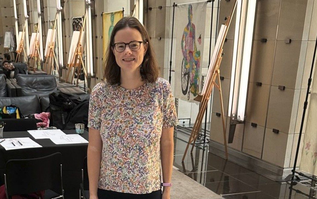 Dr Erin Turbit in front of a Body Map